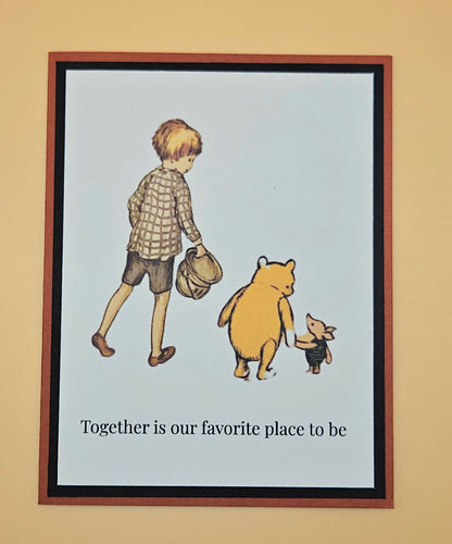 Framed illustration of a boy, bear, and piglet with text 'Together is our favorite place to be' on a beige wall.