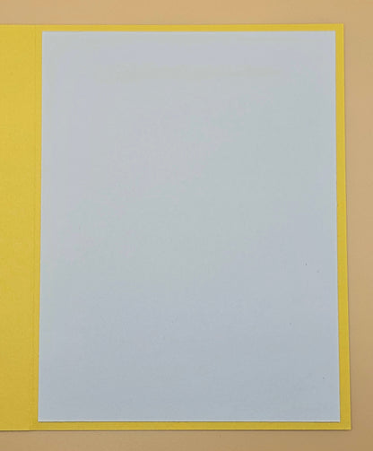 White sheet of paper with a yellow border on a beige background