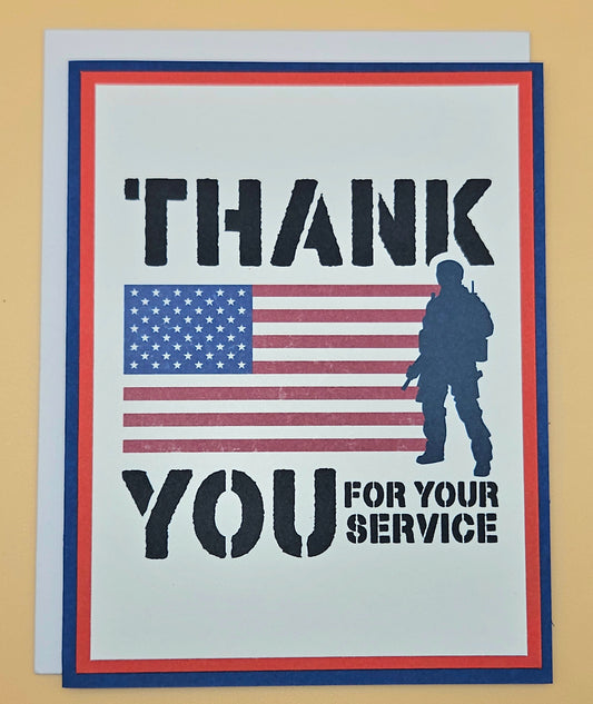 Handmade Veterans Day card with bold military stencil typography American flag and soldier silhouette on white inner panel with red and navy borders. Text reads Thank You for Your Service.