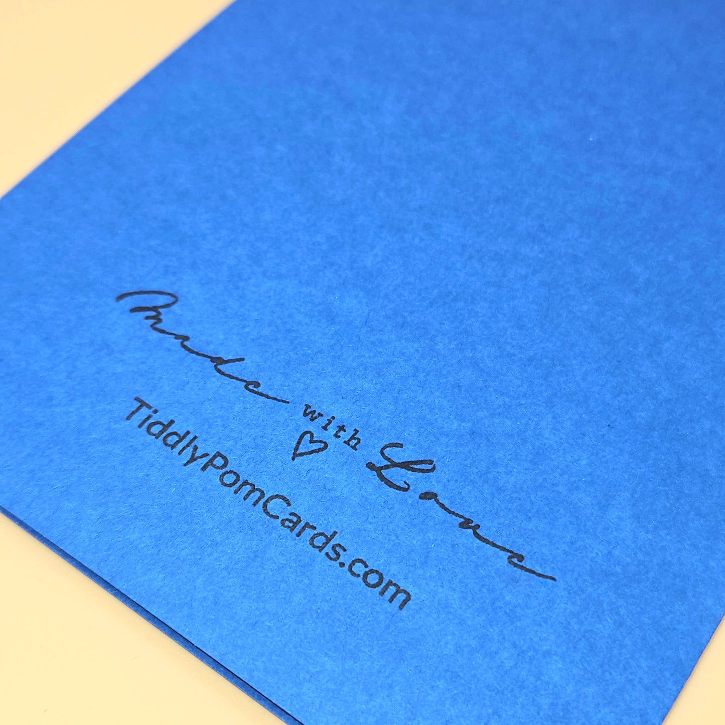 Blue card with 'Made with Love' text and tiddlypomcards.com on a beige background