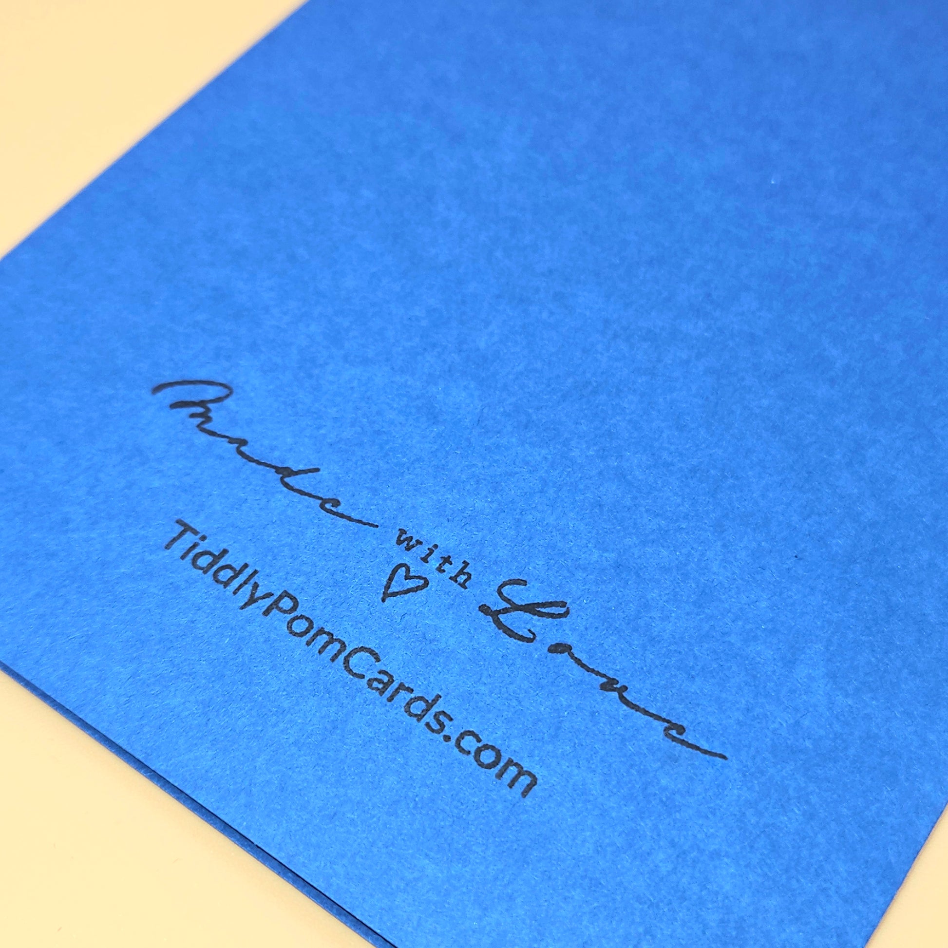 Blue card with 'Made with Love' text and tiddlypomcards.com on a beige background