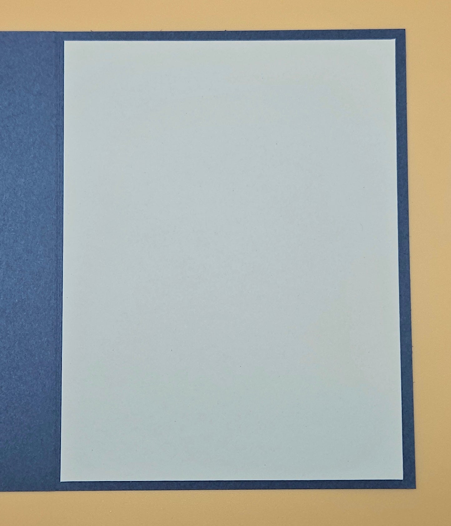 Plain white card with blue border on a beige background