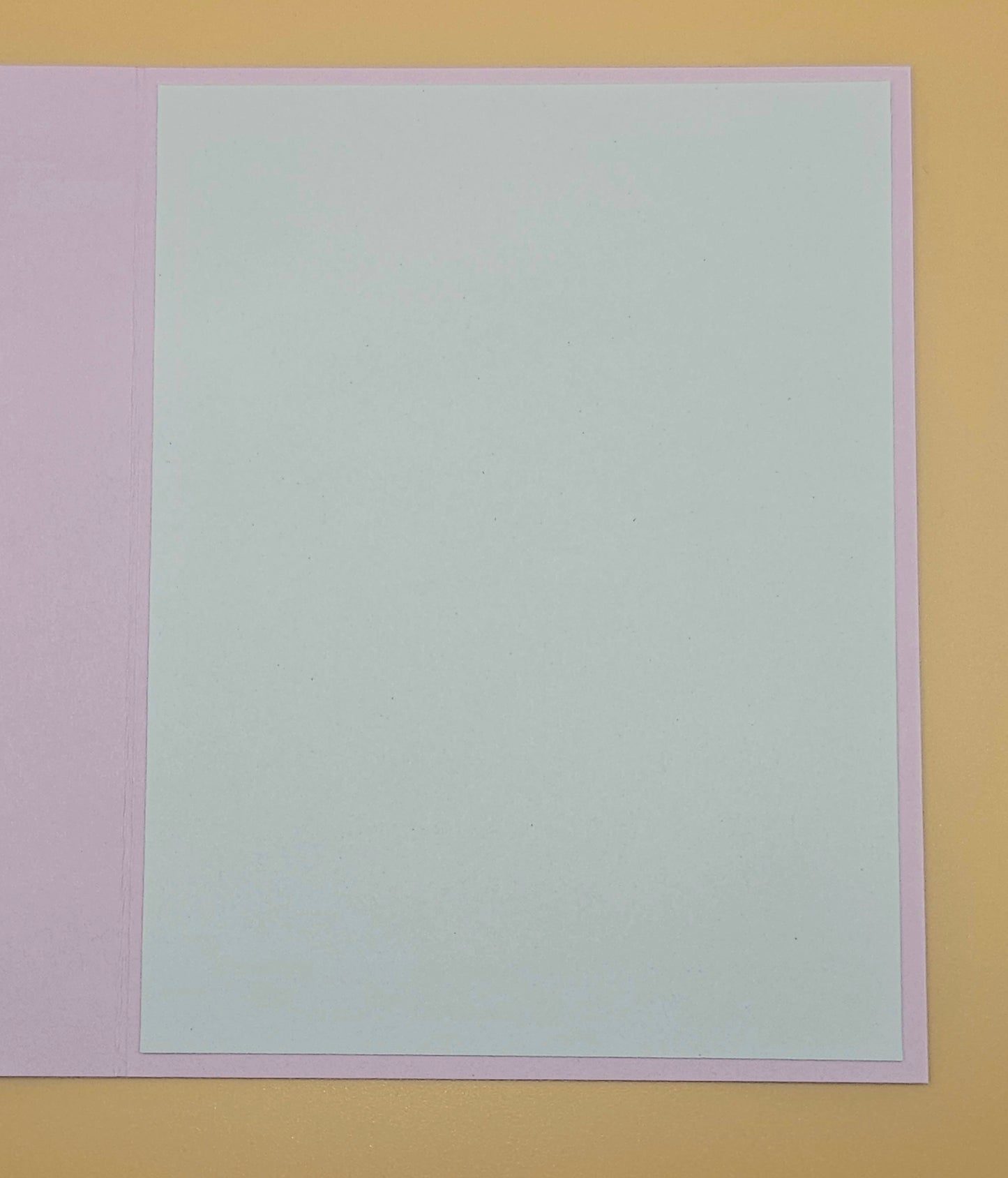 Solid light gray color swatch on a multicolored background