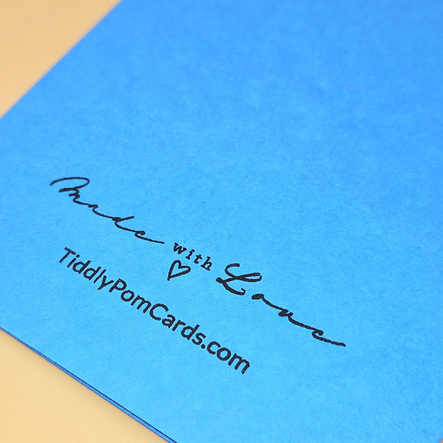 Blue card with 'Made with Love' text and TiddlyPomCards.com on a beige background