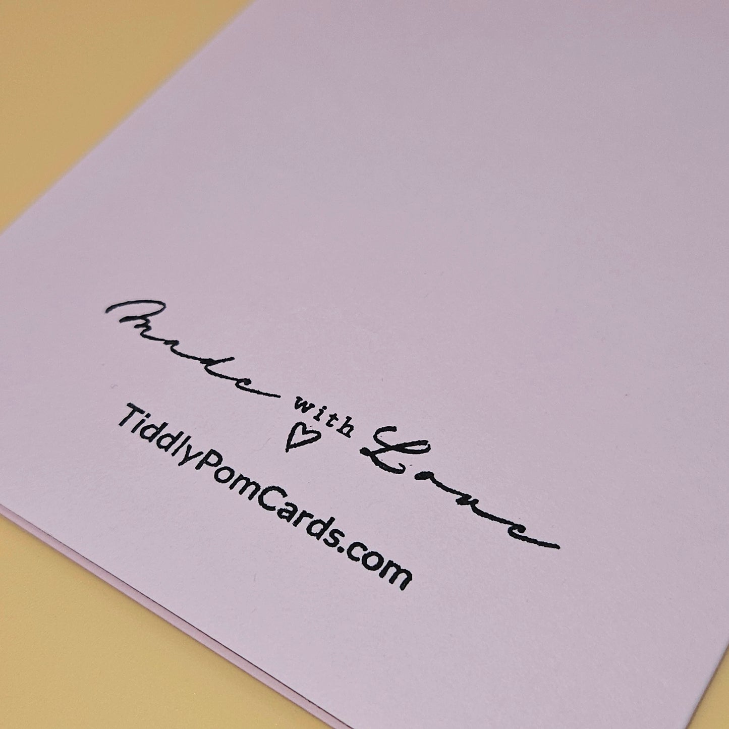 Greeting card with 'Made with Love' text and TiddlyPomCards.com on a light purple background