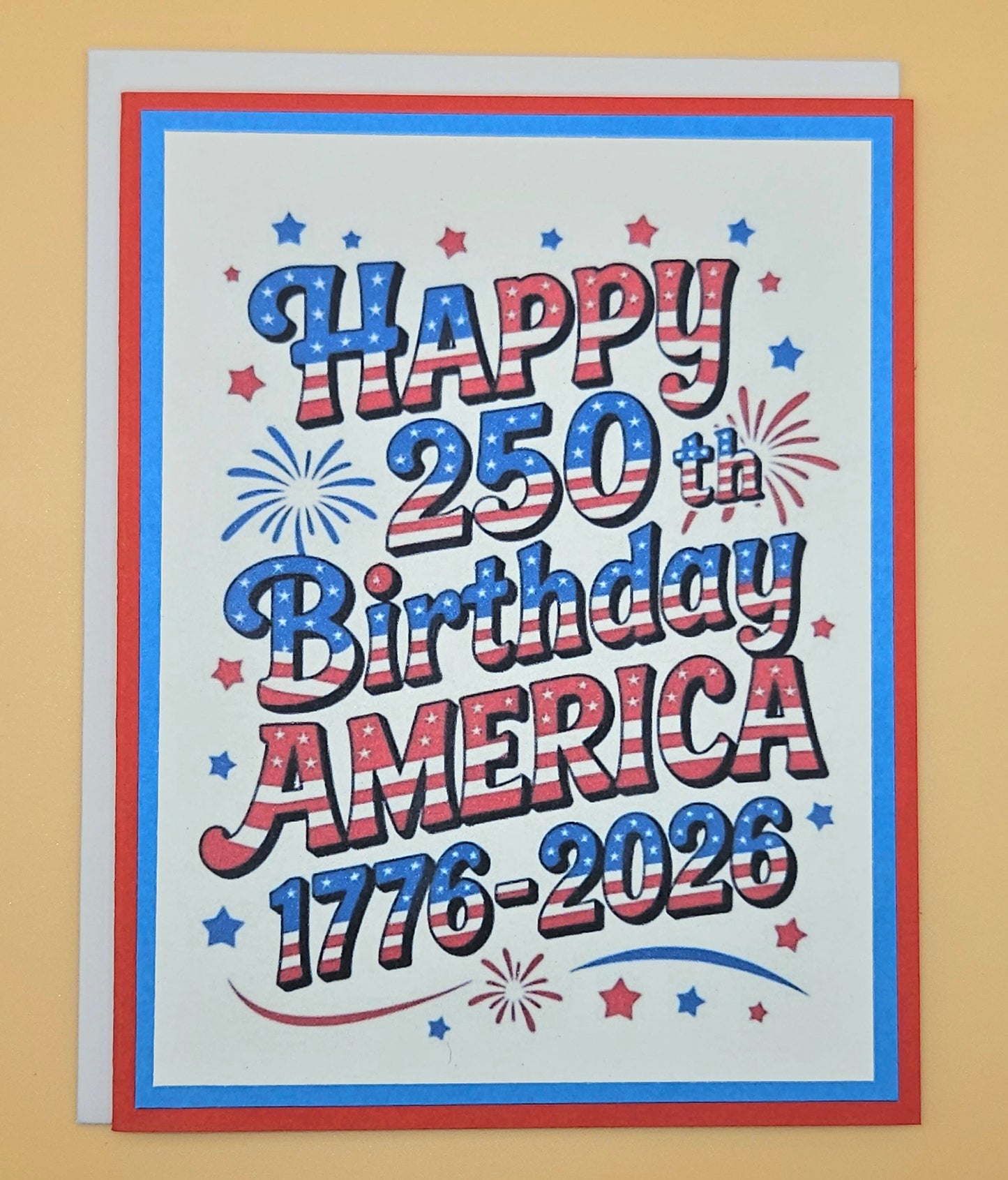 Handmade 4th of July card with bold stars and stripes typography and fireworks design on white inner panel with blue and red borders. Text reads Happy 250th Birthday America 1776-2026