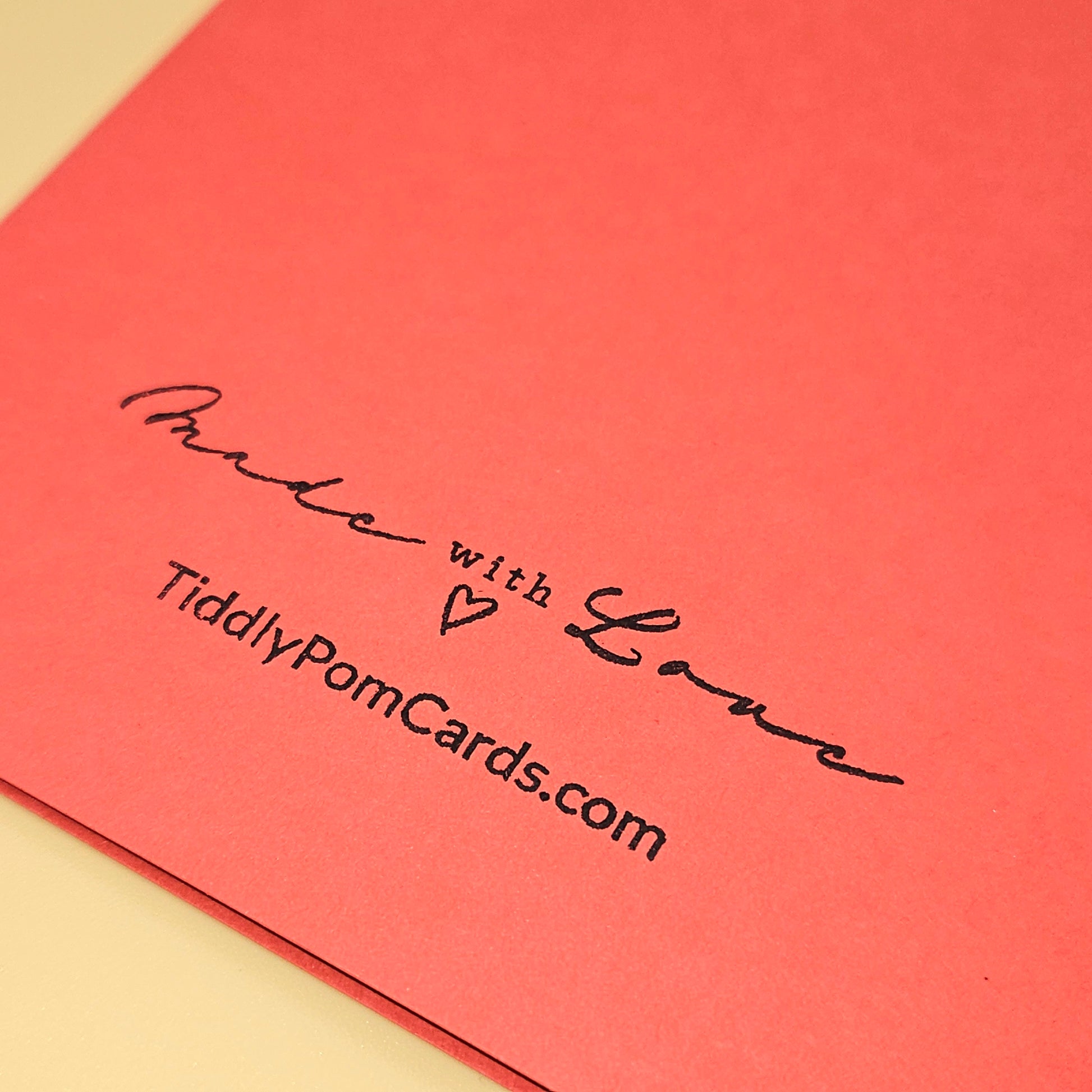Red card with 'Made with Love' text and TiddlyPomCards.com on a beige background
