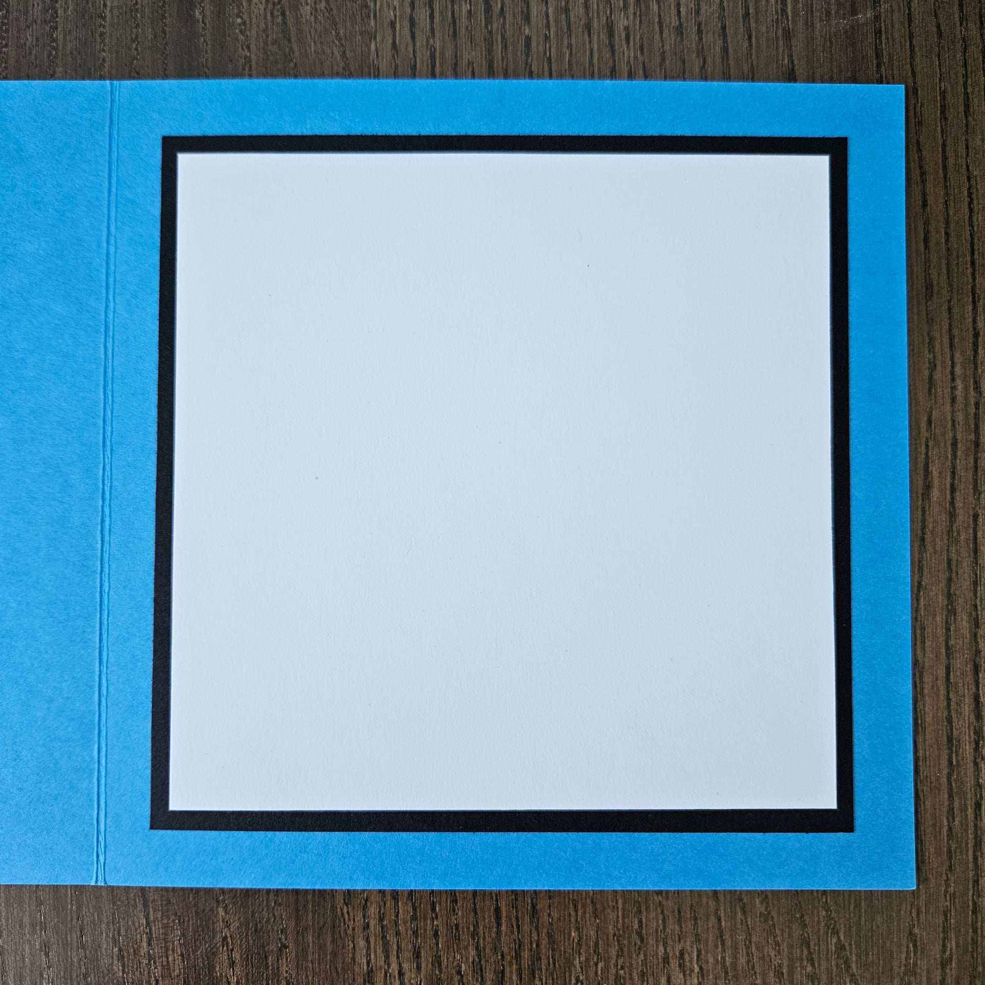 Blue border with a white center on a wooden surface