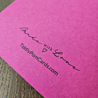 Pink card with 'Made with Love' and TiddlyPomCards.com text on a wooden surface