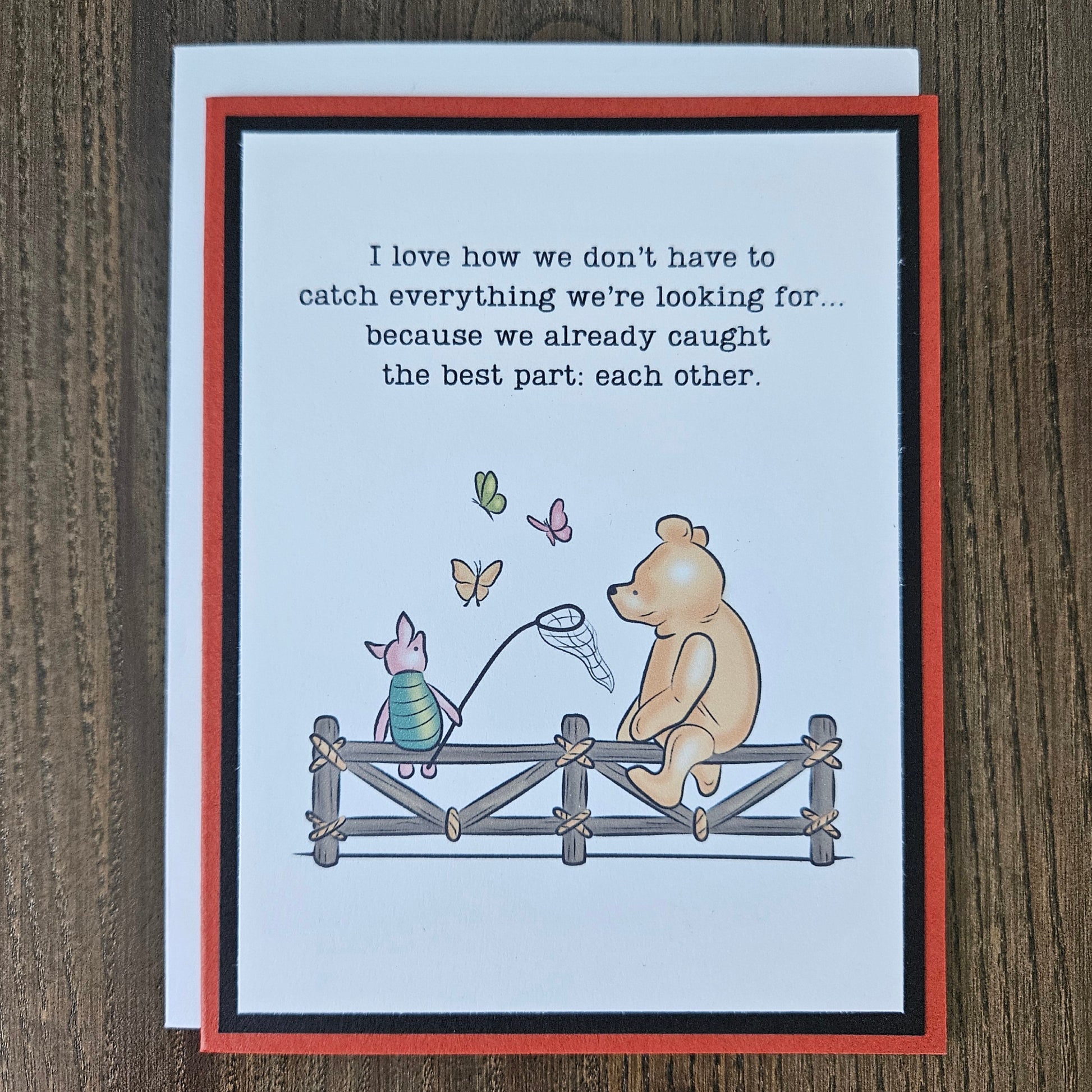 Handmade Winnie the Pooh friendship card featuring a classic storybook illustration of Pooh Bear and Piglet sitting together on a rustic wooden fence watching butterflies, finished with layered cardstock frames.