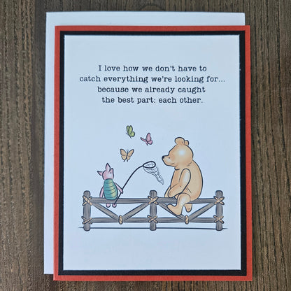 Handmade Winnie the Pooh friendship card featuring a classic storybook illustration of Pooh Bear and Piglet sitting together on a rustic wooden fence watching butterflies, finished with layered cardstock frames.