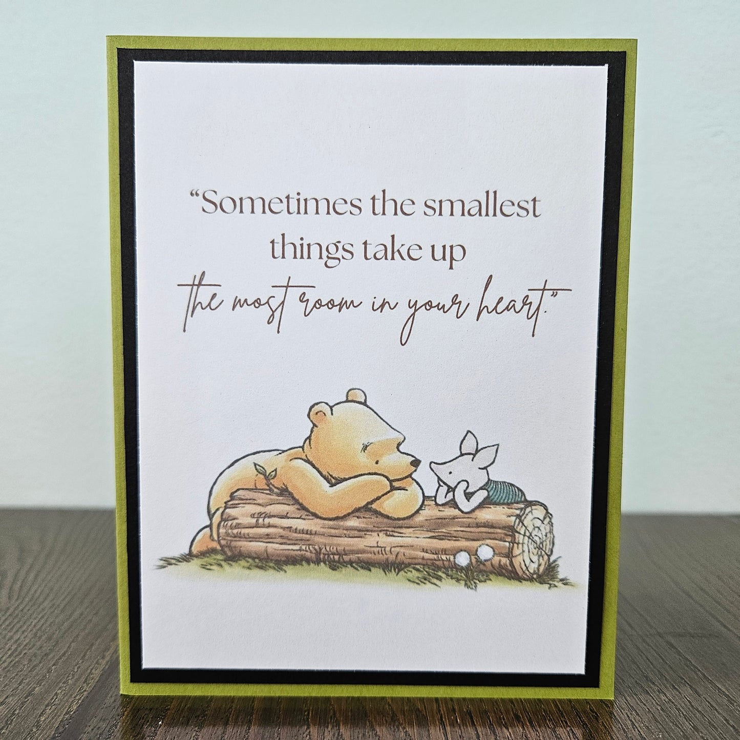 Card with a bear and butterfly illustration and a quote on a white background
