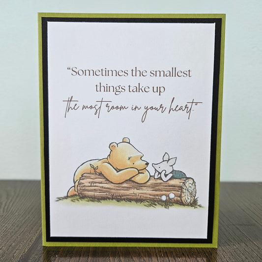 Card with a bear and butterfly illustration and a quote on a white background