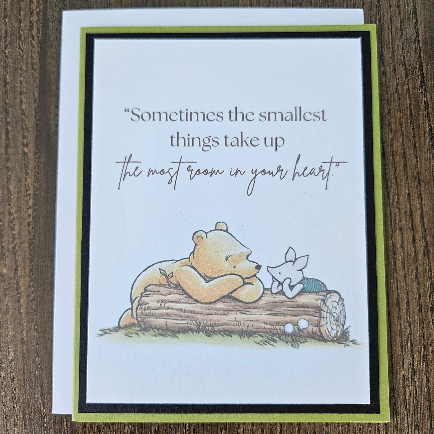 Card with Winnie the Pooh and Piglet on a log, featuring a quote.