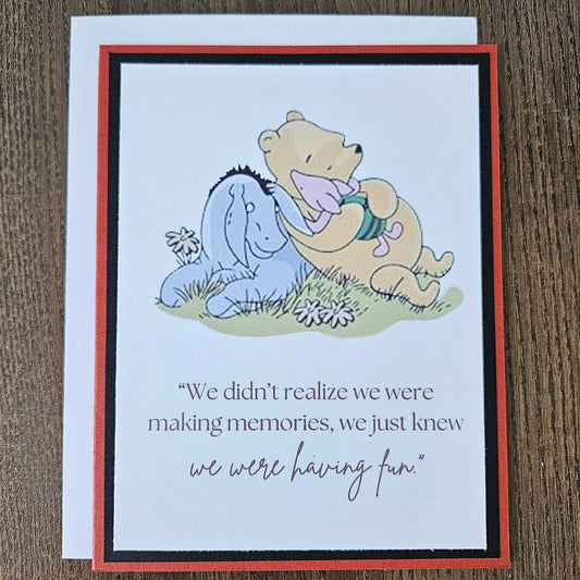 Greeting card with cartoon characters and text on a wooden surface