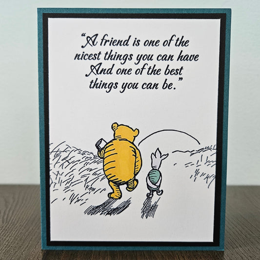 Framed print with Winnie the Pooh and Piglet walking together and a quote about friendship.