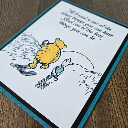 Card with cartoon bear and text on a wooden surface