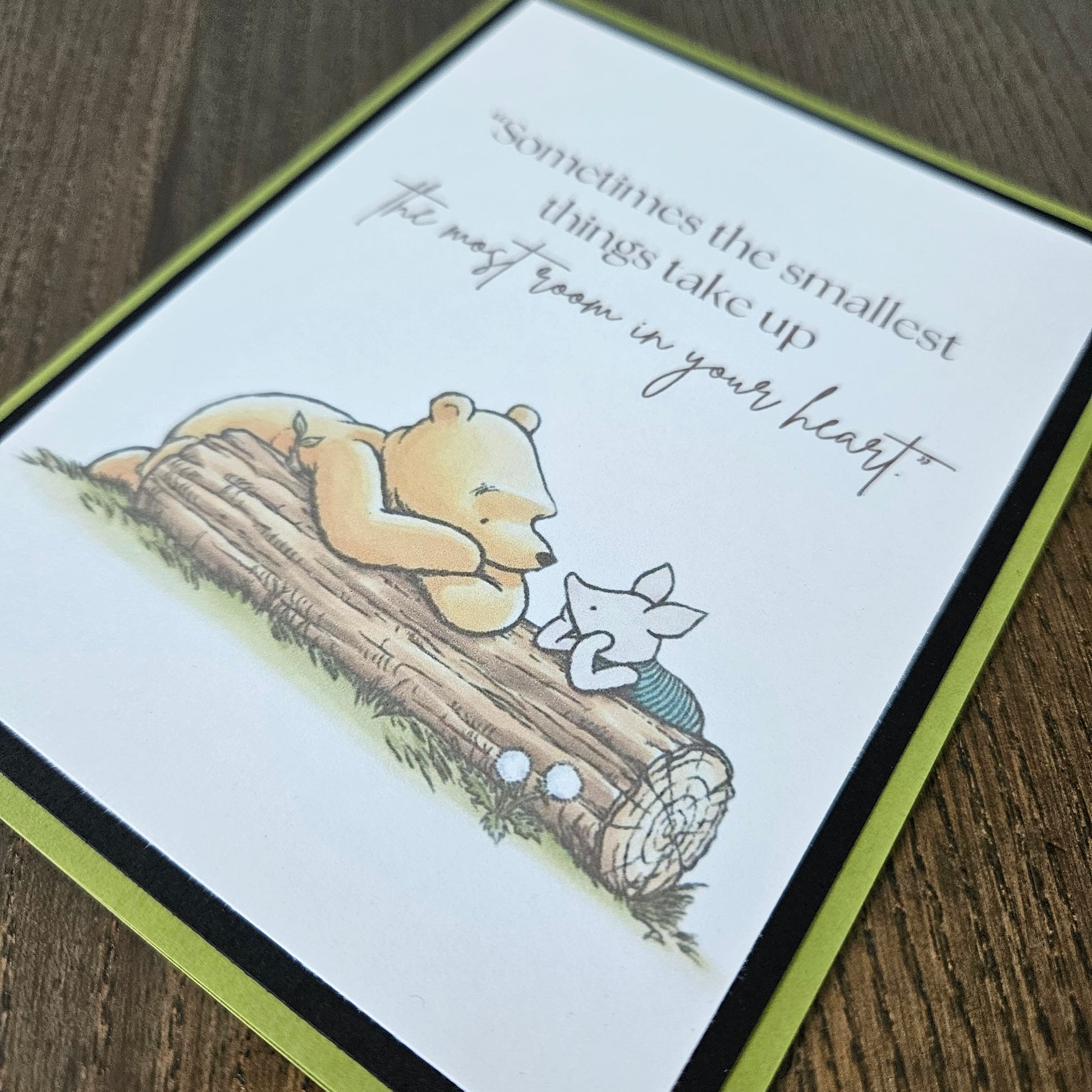 Card with a bear illustration and text on a wooden surface