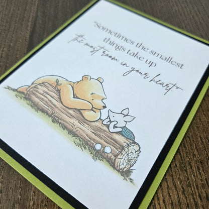 Card with a bear illustration and text on a wooden surface