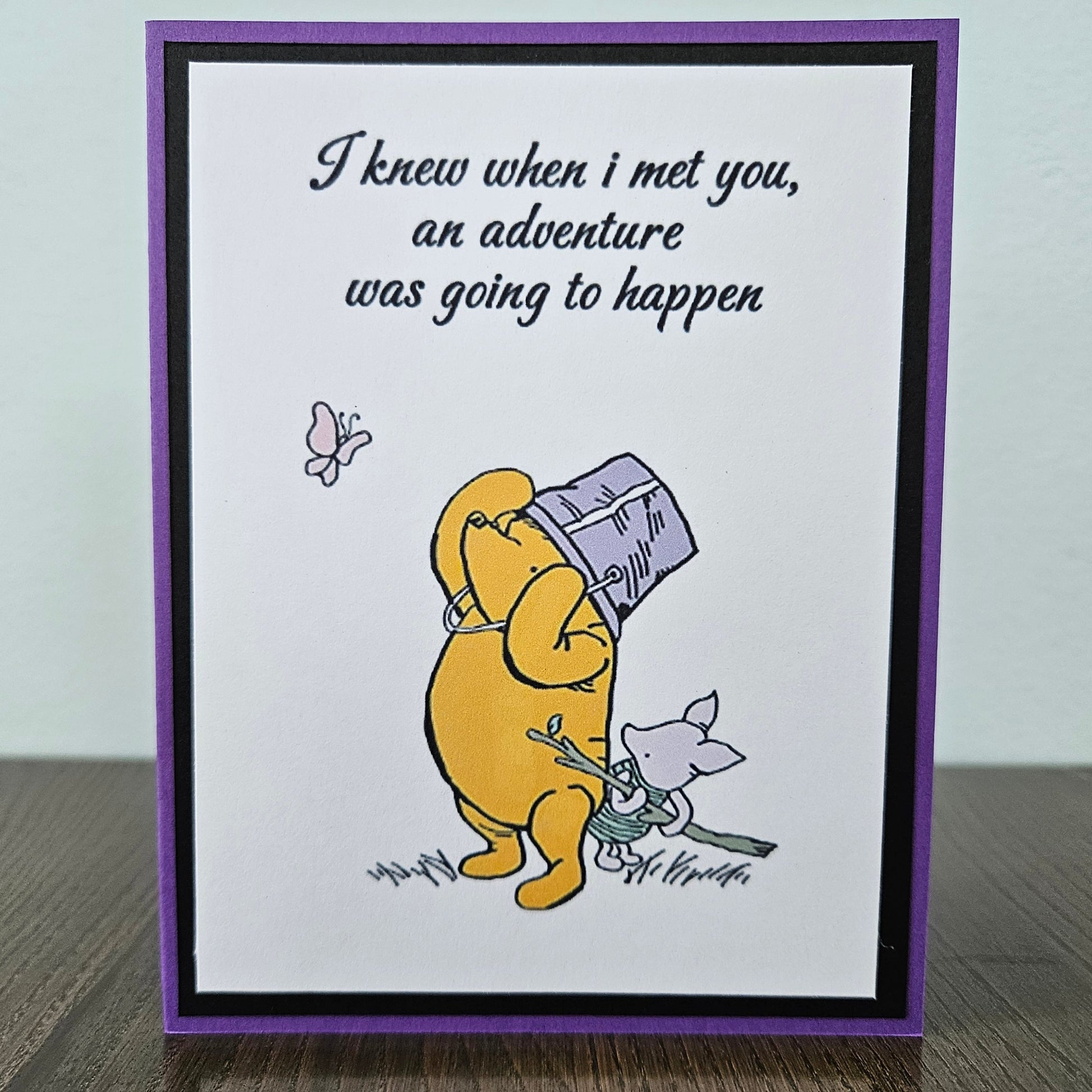 Card with cartoon bear holding a map and text 'I knew when I met you, an adventure was going to happen' on a white background.