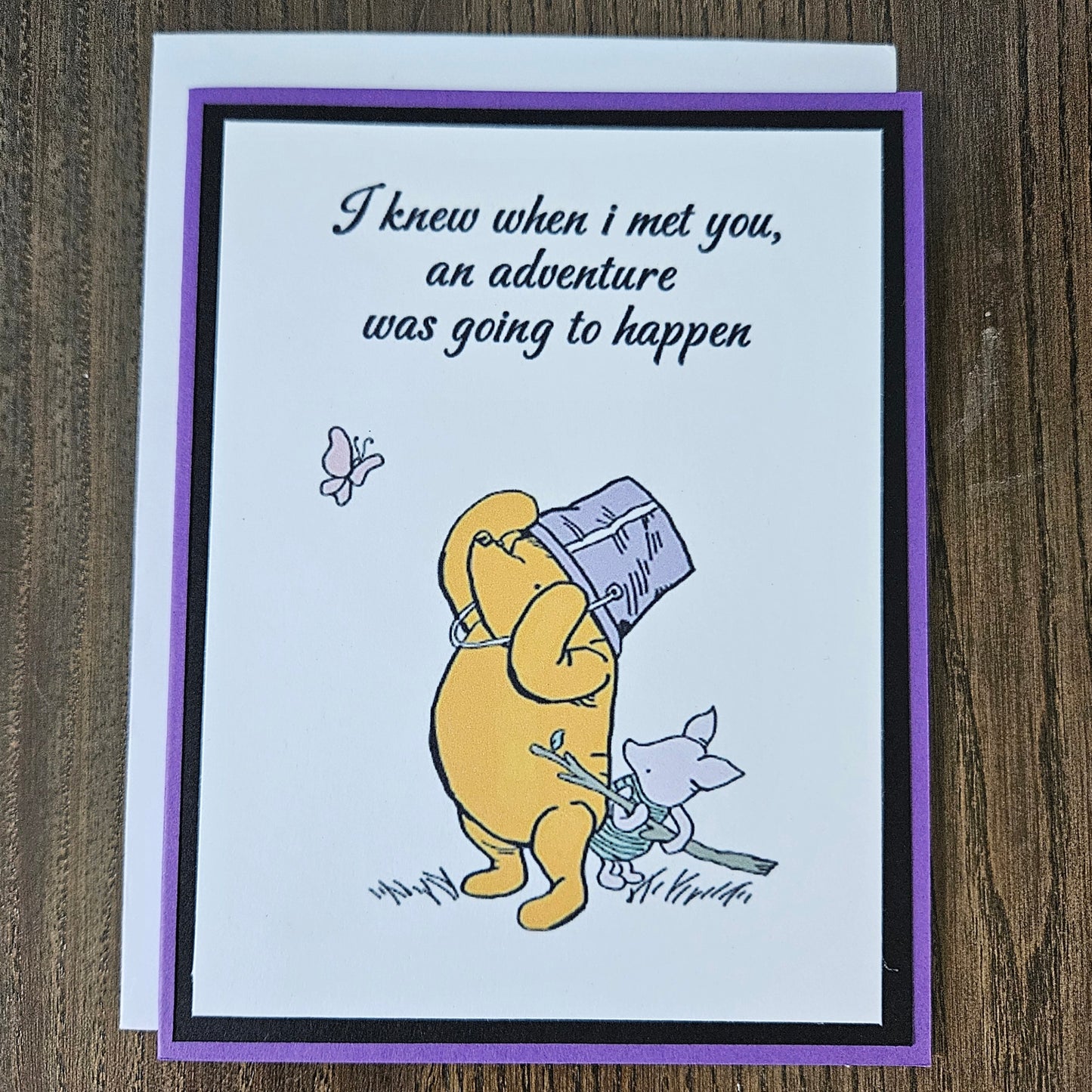 Card with cartoon character and text on a wooden surface