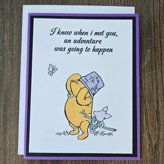 Card with cartoon character and text on a wooden surface