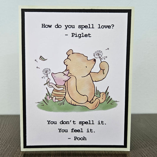 Handmade Winnie the Pooh friendship card featuring a classic hand-colored illustration of Pooh Bear and Piglet walking together, framed by layered cardstock with the quote How do you spell love.
