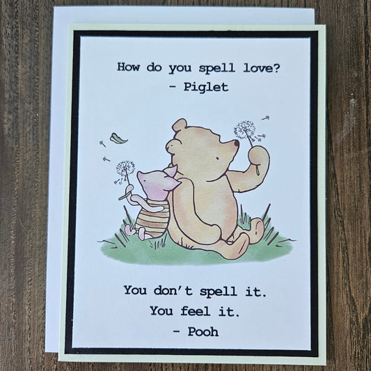 Card with cartoon characters and text on a wooden surface
