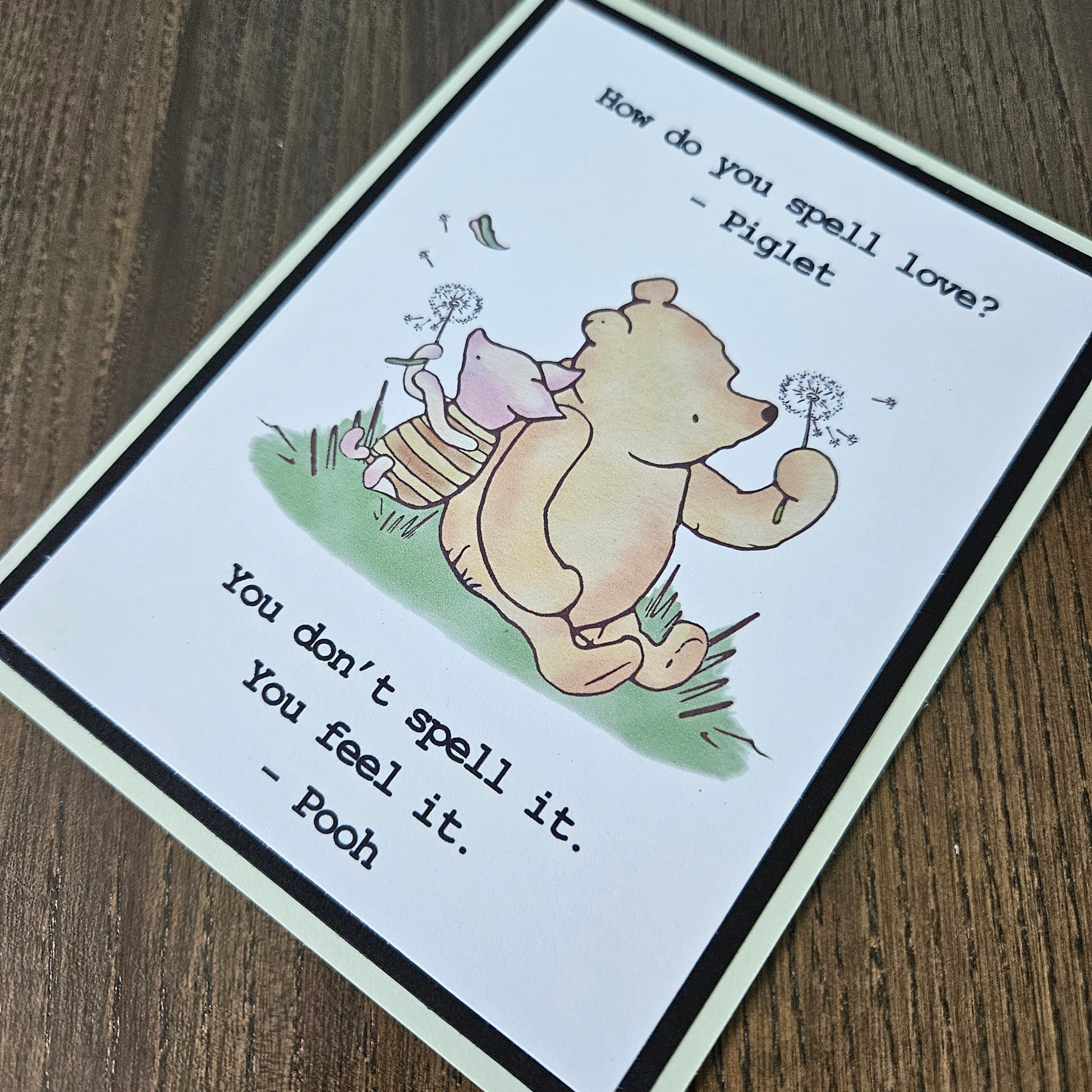 Handmade Winnie the Pooh friendship card featuring a classic hand-colored illustration of Pooh Bear and Piglet walking together, framed by layered cardstock with the quote How do you spell love.