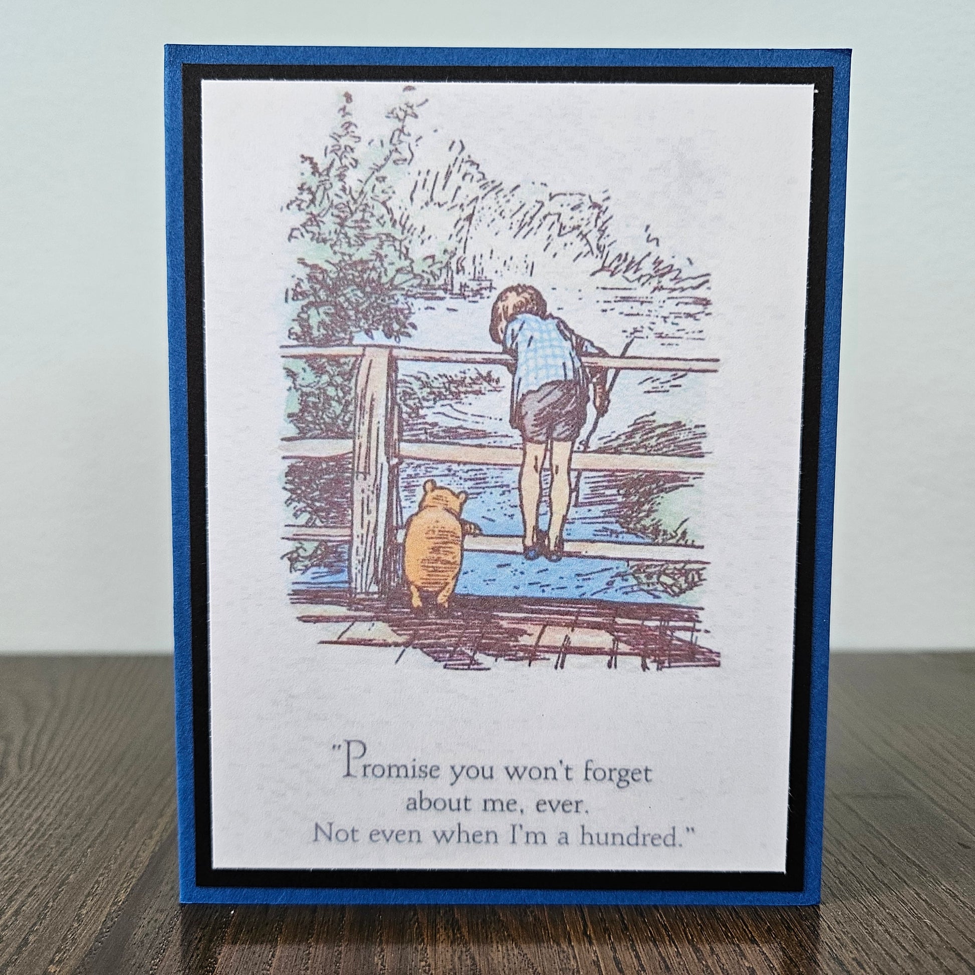 Card with illustration of a child and bear by a fence, with text 'Promise you won't forget about me, ever. Not even when I'm a hundred.