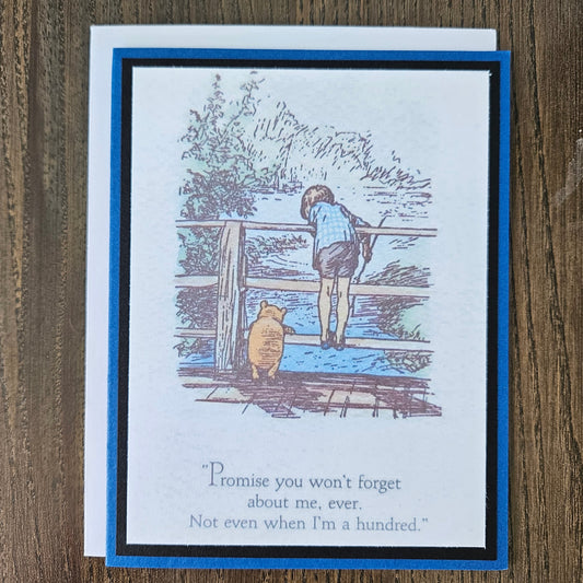 Greeting card with illustration of a person and a dog on a wooden staircase, on a wooden surface.
