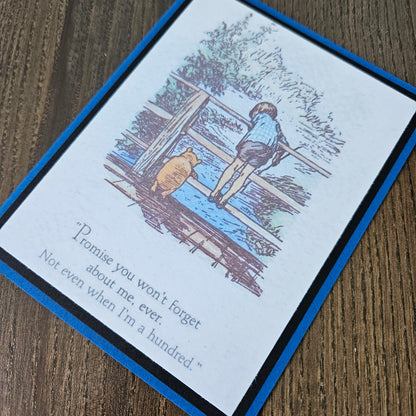 Greeting card with illustration of a boy and dog on a ladder, text on a wooden surface
