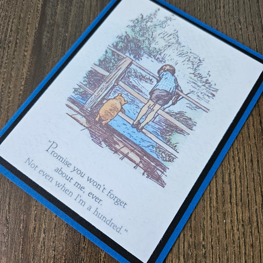 Greeting card with illustration of a boy and dog on a ladder, text on a wooden surface