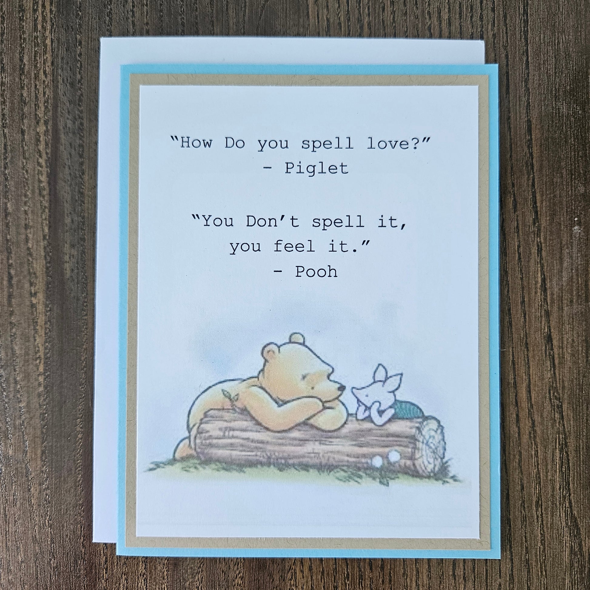 Card with Winnie the Pooh and Piglet sitting on a log, featuring a quote between them.
