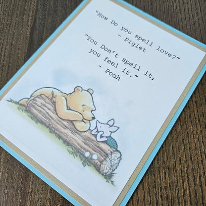 Card with Winnie the Pooh and Piglet sitting on a log, featuring a quote between them.