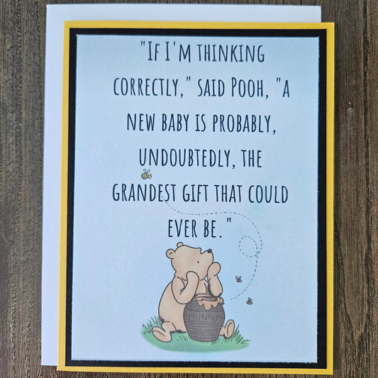Greeting card with Winnie the Pooh illustration and text on a wooden surface
