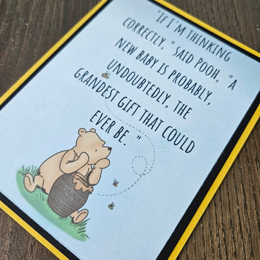 Card with cartoon bear and humorous text on a wooden surface