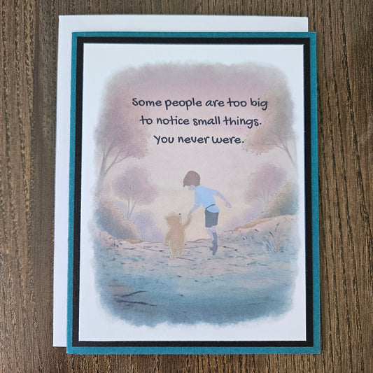 Greeting card with illustration of two people on a beach and text on a wooden surface