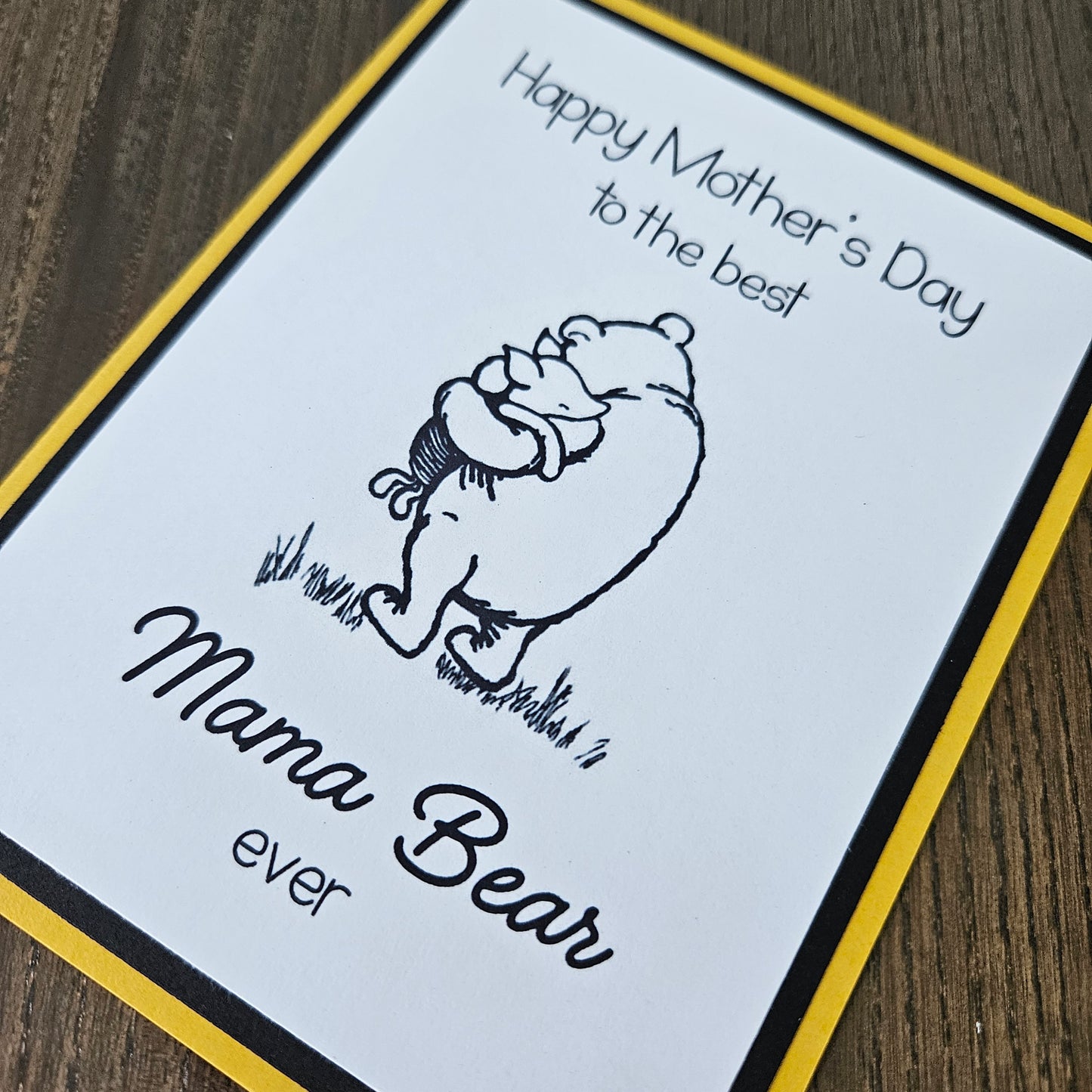 Winnie The Pooh Mother's Day card with text 'Happy Mother's Day to the best Mama Bear ever' on a beige background.