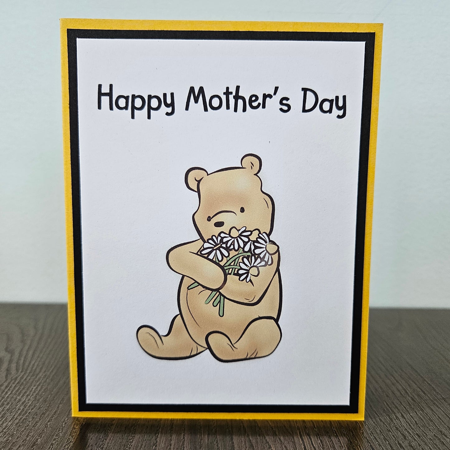 Mother's Day card with a bear holding flowers on a beige background