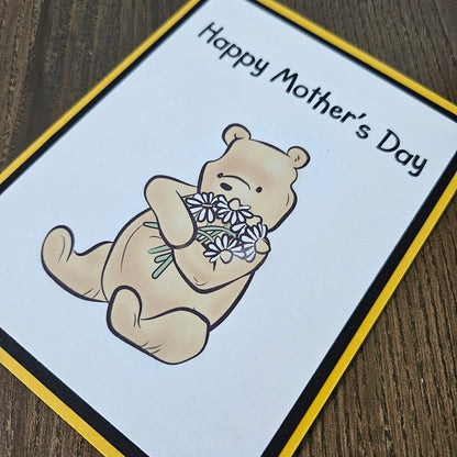 Mother's Day card with a bear holding flowers on a beige background