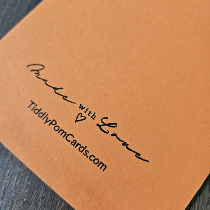 Brown card with 'Made with Love' and TiddlyPomCards.com text on a wooden surface