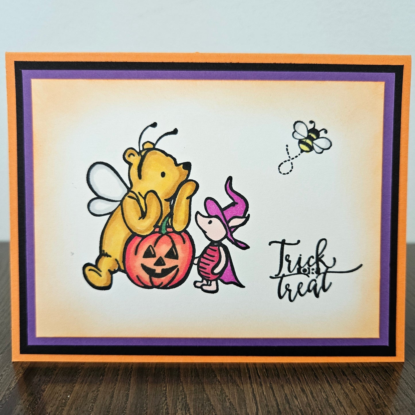 Halloween-themed card with a bear and fairy characters and 'Trick or Treat' text.