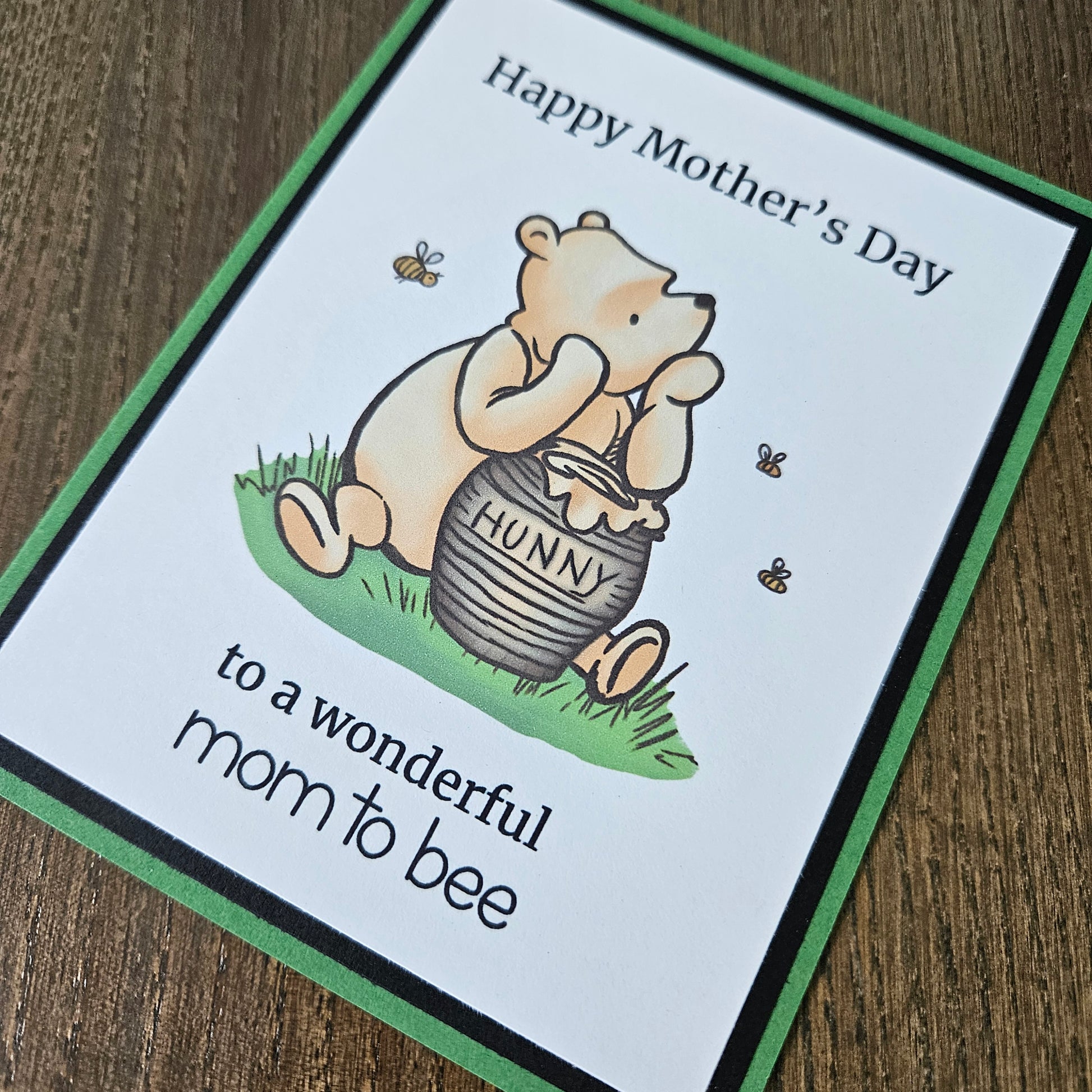 Winnie The Pooh Mother's Day card for mom to be holding a honey pot and text on a beige background