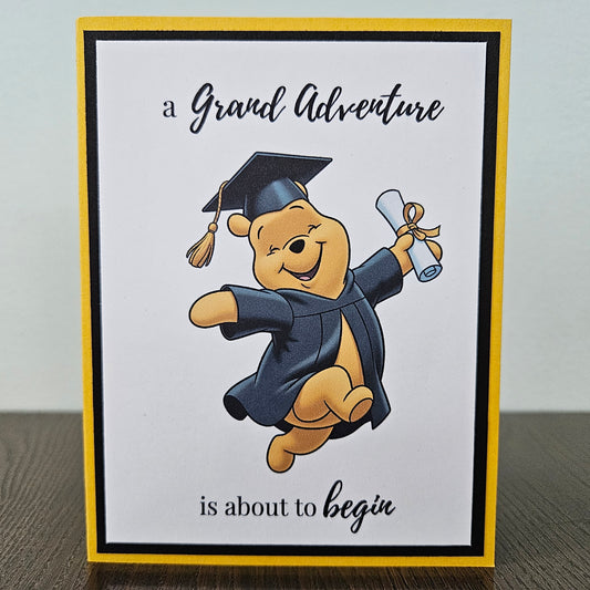 Graduation-themed card with Winnie the Pooh in a cap and gown holding a diploma.