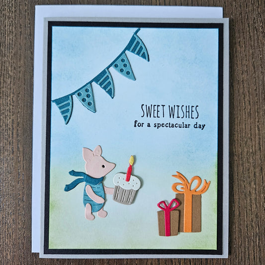 Greeting card with cartoon pig and fish design on a wooden surface