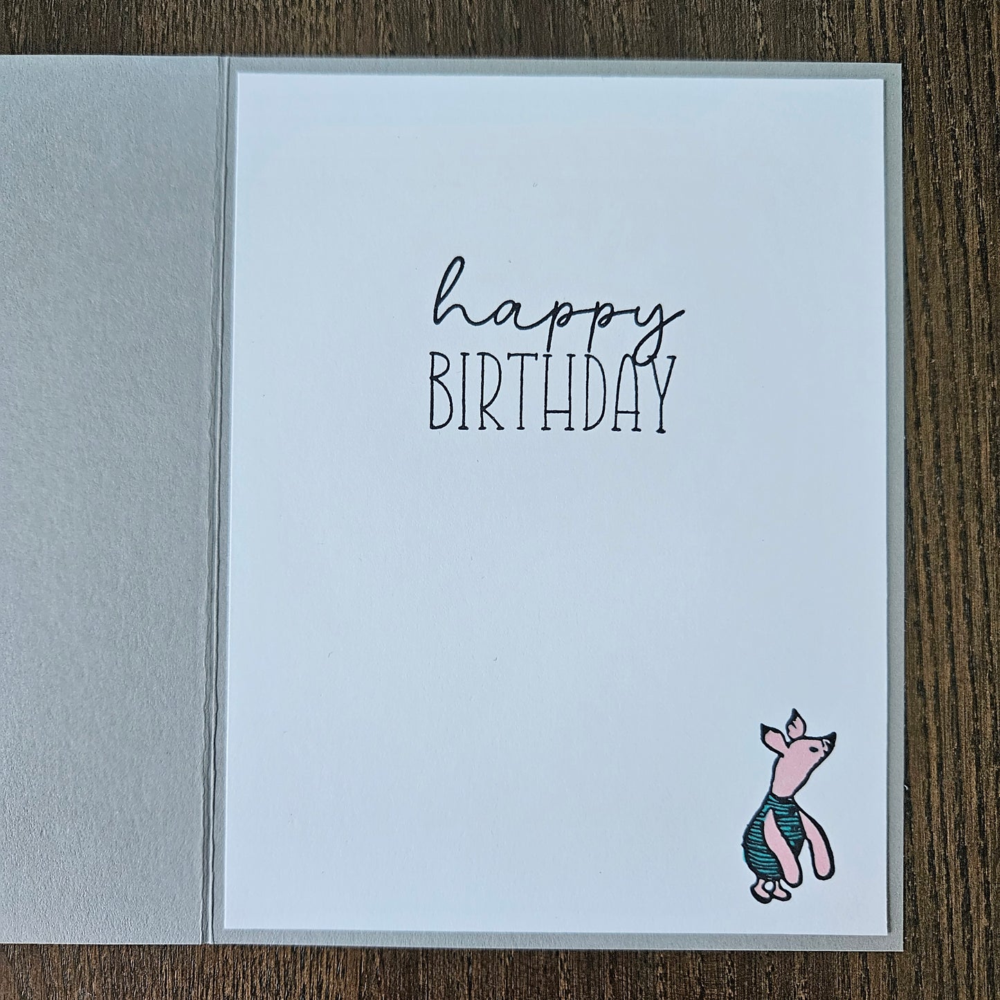 Birthday card with a fish illustration and 'Happy Birthday' text on a wooden surface