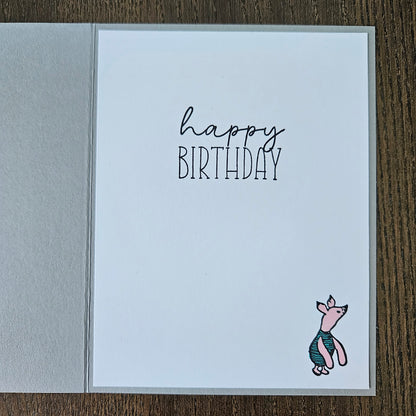 Birthday card with a fish illustration and 'Happy Birthday' text on a wooden surface