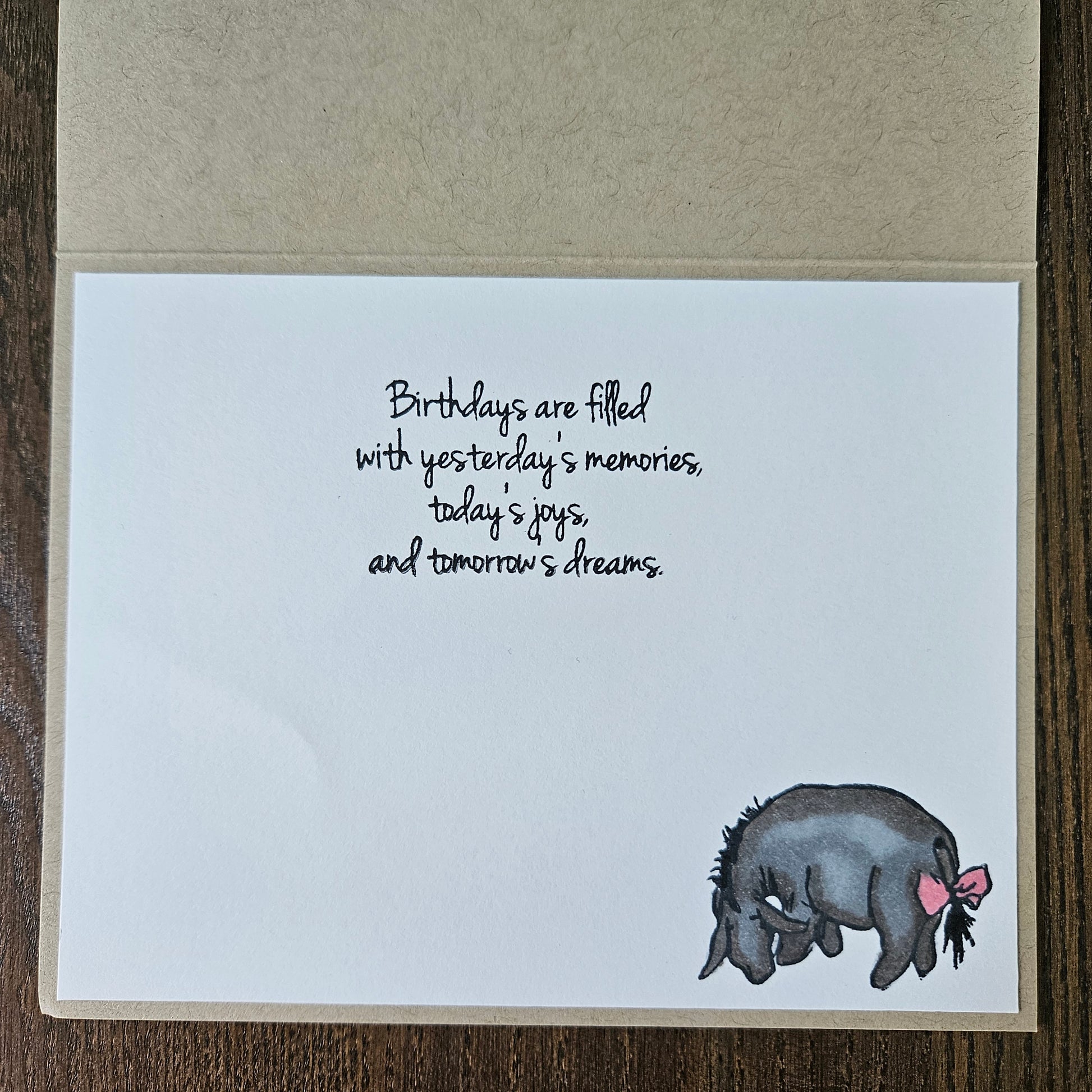 Inside panel of the card displaying the printed sentiment text reading Birthdays are filled with yesterday's memories today's joys and tomorrow's dreams with a small classic donkey illustration in the corner.