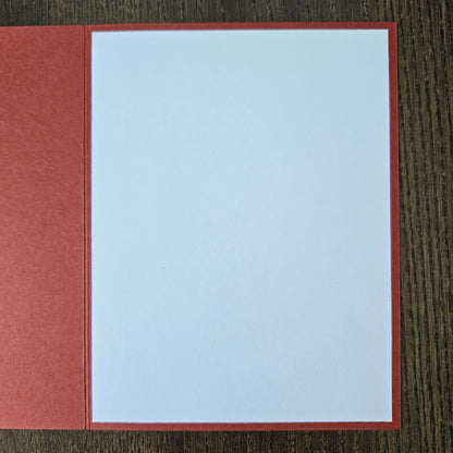Red card with a white square on a wooden surface